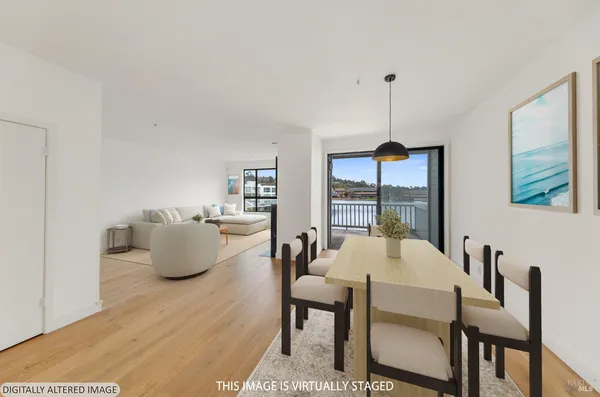 a living room with furniture a fireplace and a large window