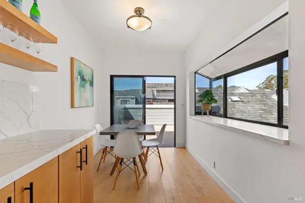 a view of empty room with wooden floor and fireplace