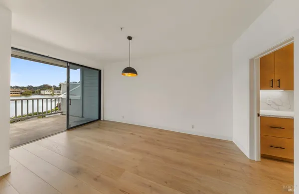 an empty room with a mirror and a cabinet