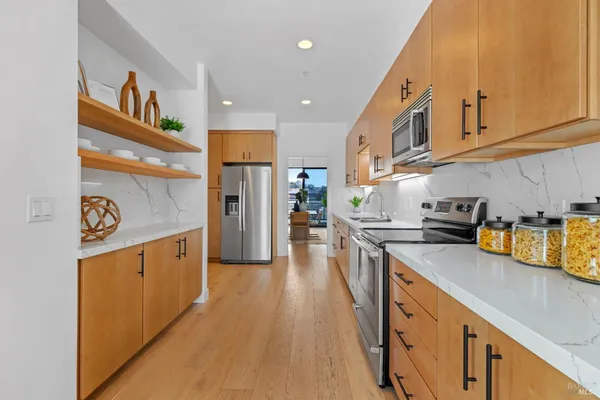 a bathroom with a double vanity sink mirror and bathtub