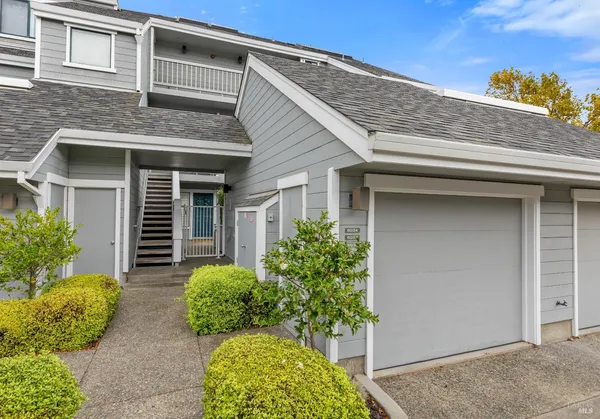 a kitchen with a sink a counter top space stainless steel appliances and cabinets