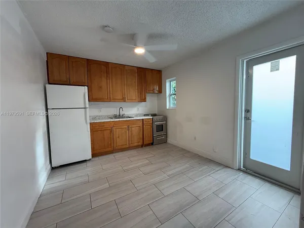 a kitchen with a cabinets a sink and a refrigerator