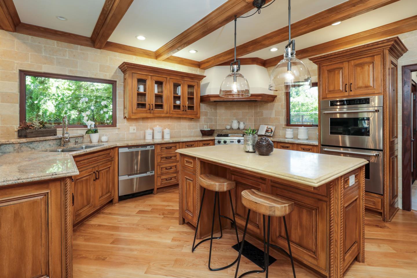 255 Lyell Street Los Altos, CA 94022 - Photo 17 of 50 a kitchen with stainless steel appliances granite countertop a sink a stove and wooden cabinets