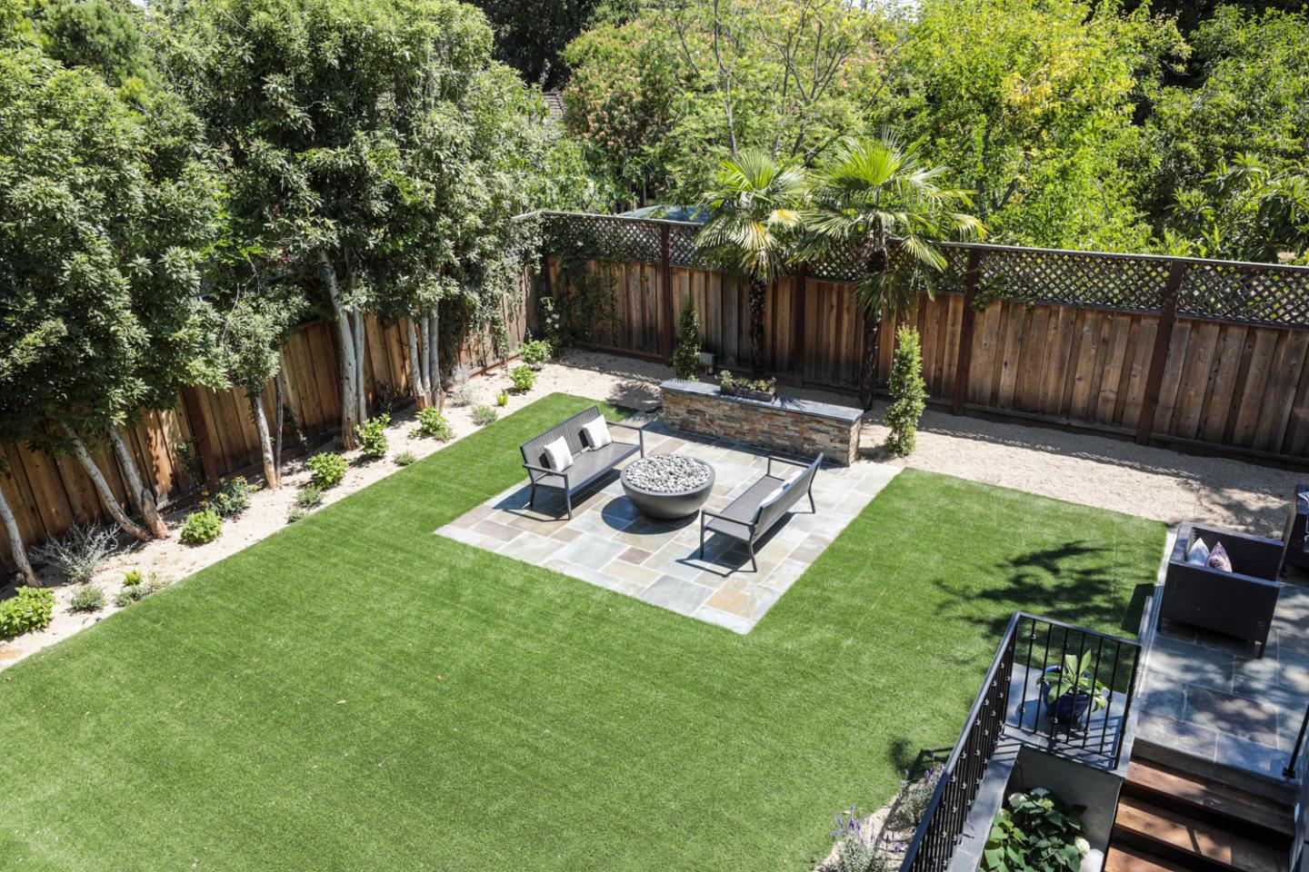 255 Lyell Street Los Altos, CA 94022 - Photo 39 of 50 a view of a backyard with table and chairs potted plants and wooden fence