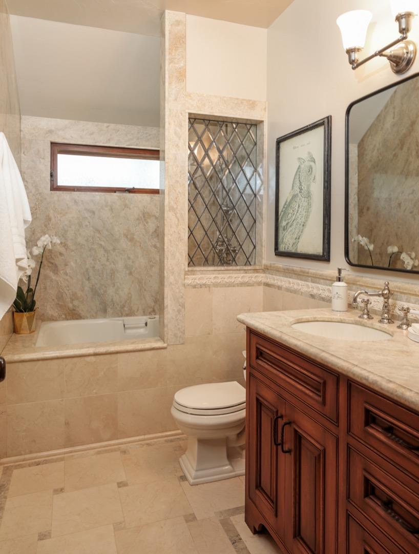 255 Lyell Street Los Altos, CA 94022 - Photo 43 of 50 a bathroom with a granite countertop toilet a sink a mirror and a window
