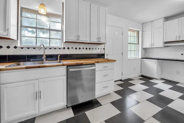 a kitchen with stainless steel appliances a stove a sink and a refrigerator