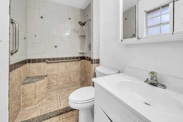 a bathroom with a sink toilet and shower