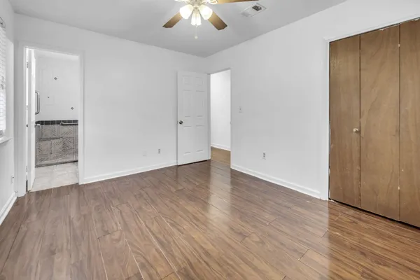 wooden floor in an empty room with a window