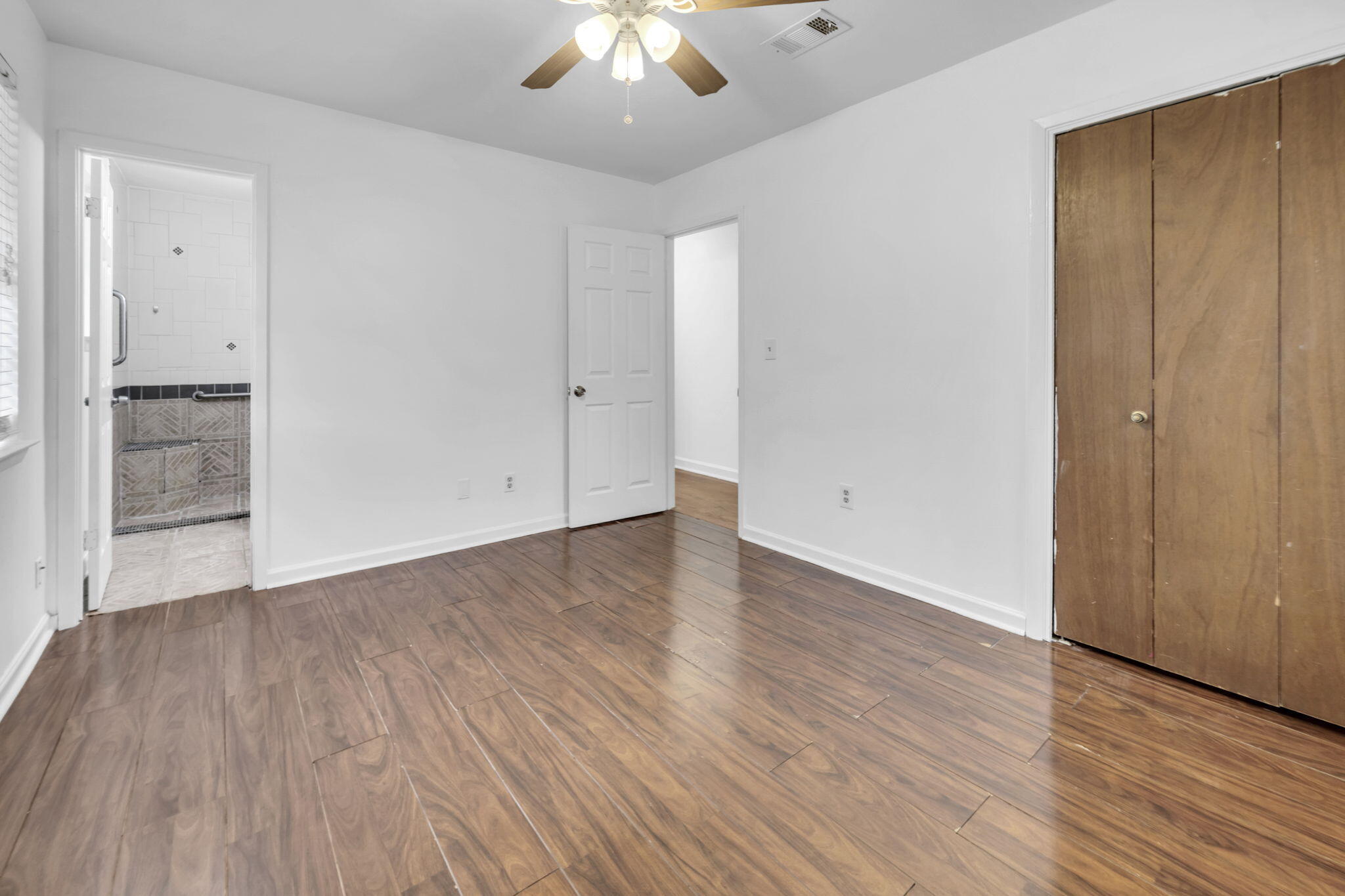 1020 Pinetree Road Mary Esther, FL 32569 - Photo 22 of 28 wooden floor in an empty room with a window