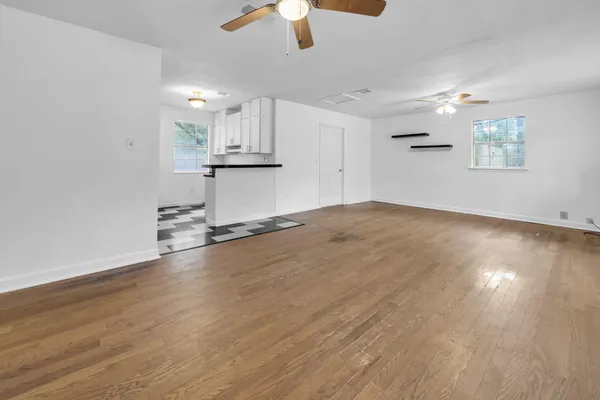 a view of a kitchen with a stove and wooden floor