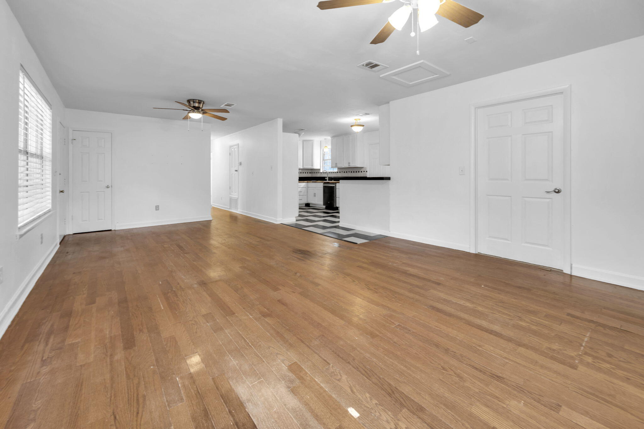 1020 Pinetree Road Mary Esther, FL 32569 - Photo 7 of 28 a view of empty room with wooden floor and ceiling fan
