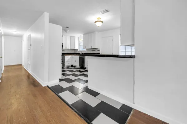 a kitchen with a refrigerator and a stove