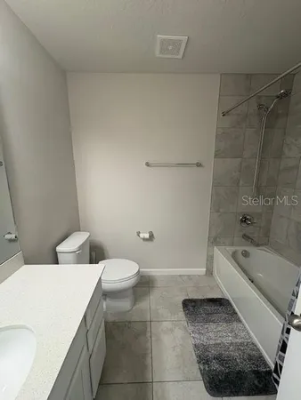 a bathroom with a sink a toilet and bathtub