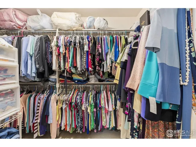 a view of walk in closet with clothes