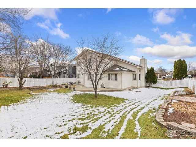 a view of a house with a yard covered in snow