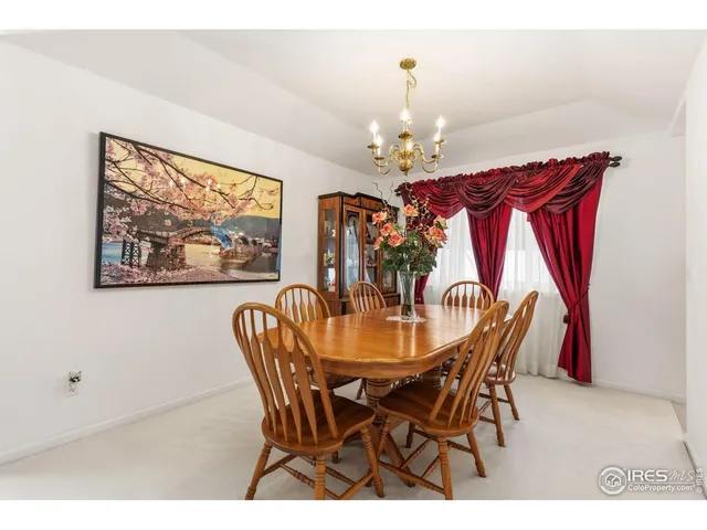 a view of a dining room with furniture a chandelier and wooden floor
