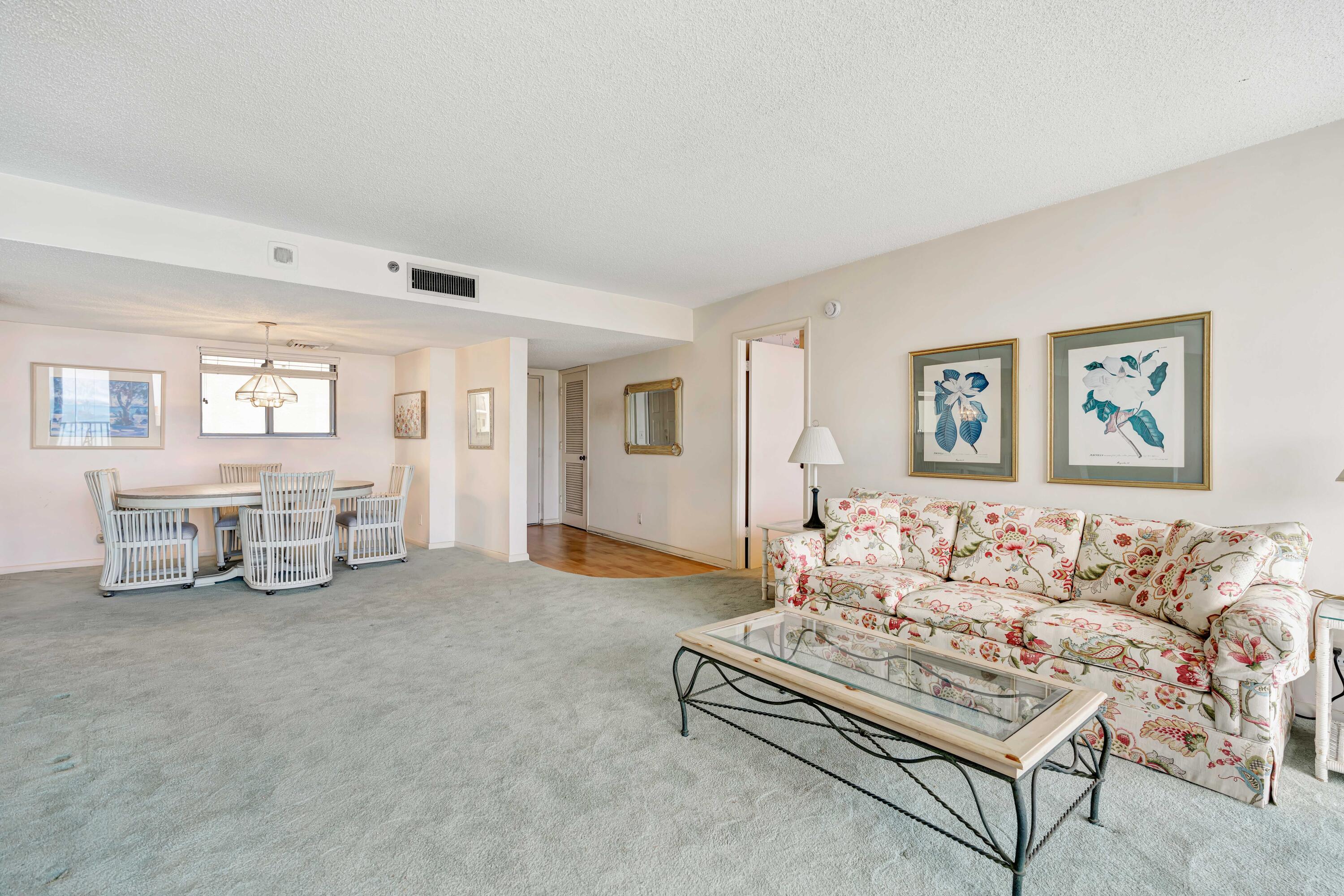 200 Ocean Trail Way, Unit 1009 Jupiter, FL 33477 - Photo 11 of 36 a spacious bedroom with a bed a couch and next to a window