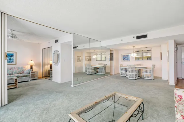 a bedroom with a bed and a chandelier fan