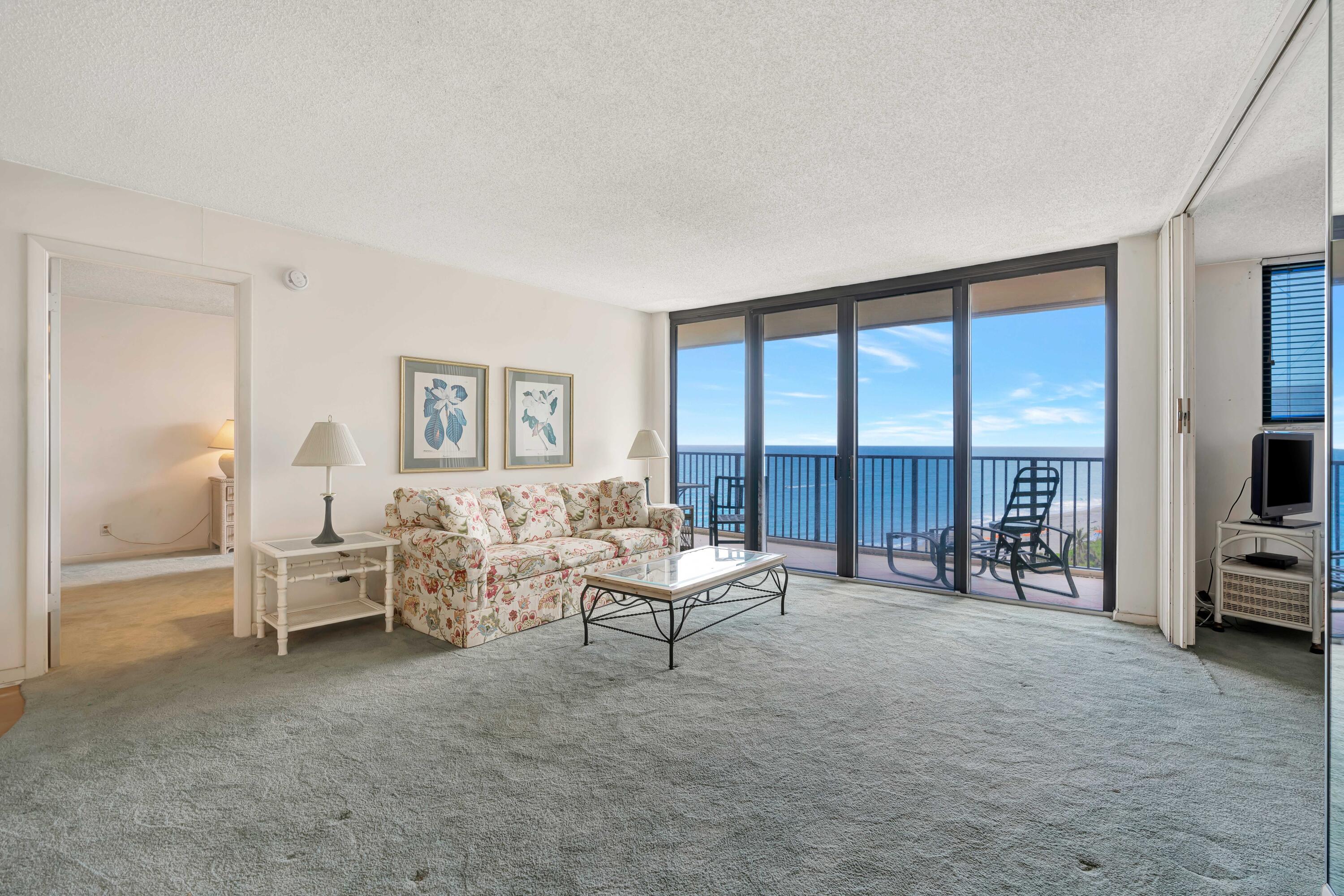 200 Ocean Trail Way, Unit 1009 Jupiter, FL 33477 - Photo 10 of 36 a living room with furniture and large windows