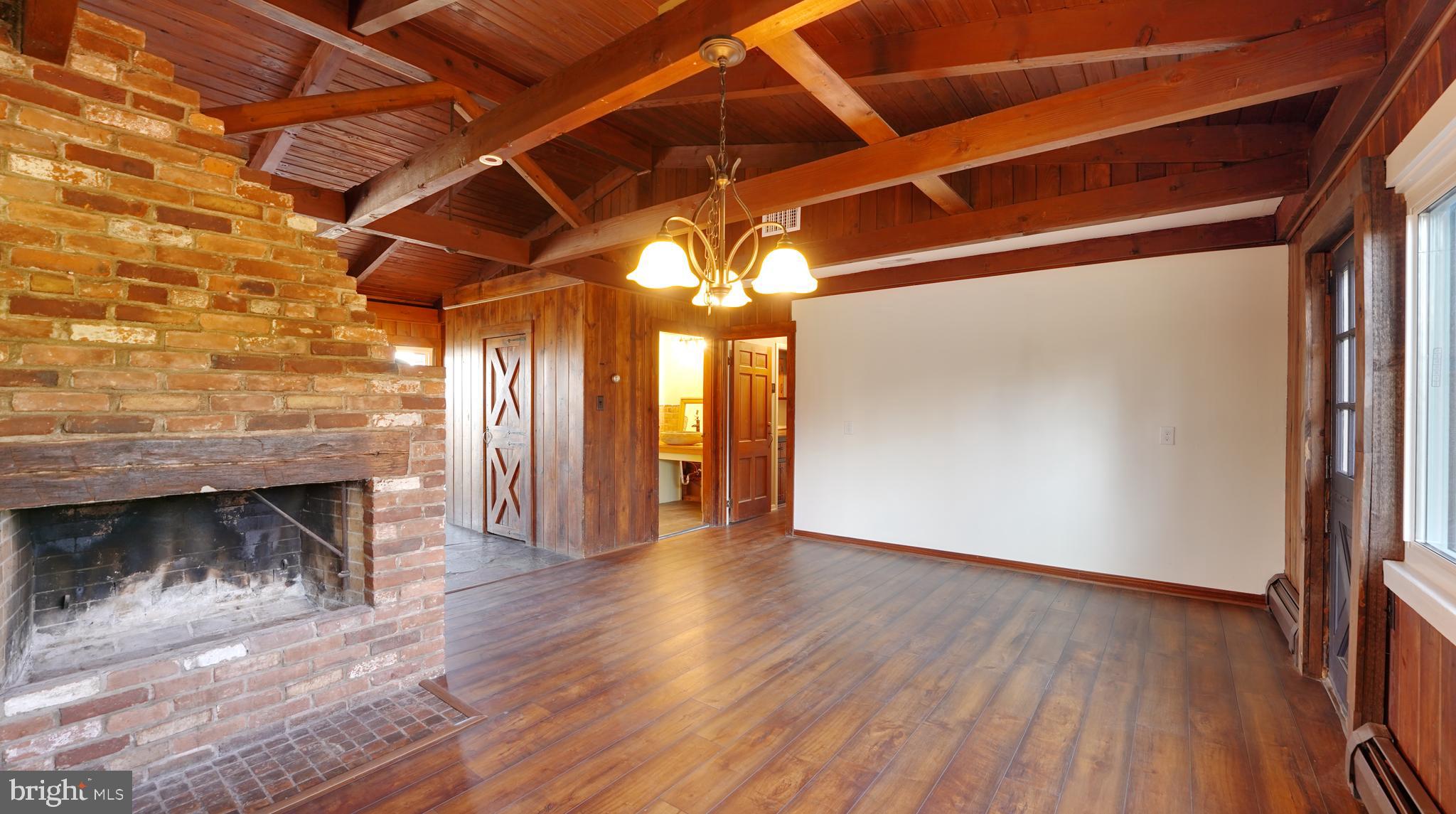 53 Iron Bridge Road Pipersville, PA 18947 - Photo 11 of 28 a view of an empty room with wooden floor and a fireplace