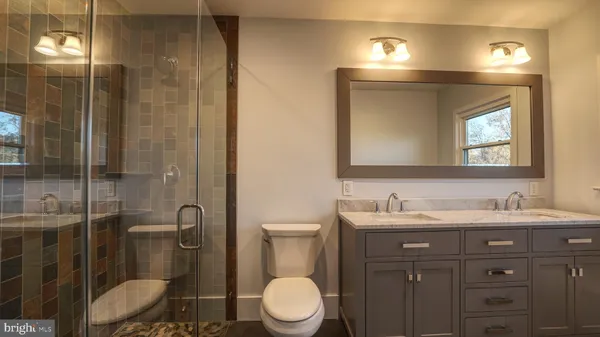 a bathroom with a toilet sink and shower