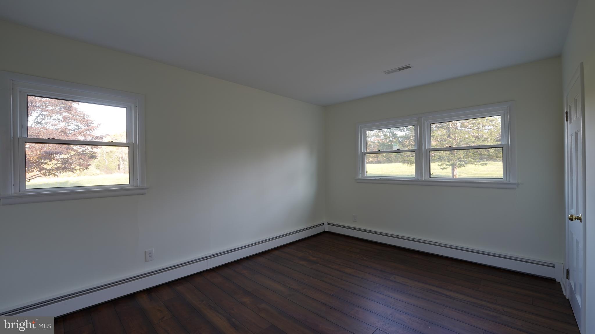 53 Iron Bridge Road Pipersville, PA 18947 - Photo 15 of 28 an empty room with wooden floor and windows