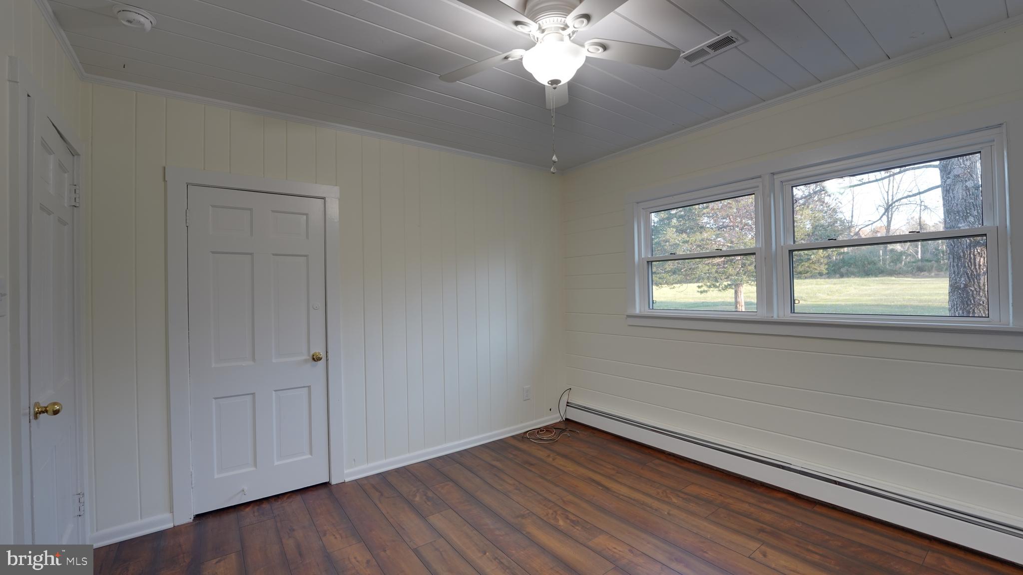 53 Iron Bridge Road Pipersville, PA 18947 - Photo 16 of 28 a view of an empty room with wooden floor and a window
