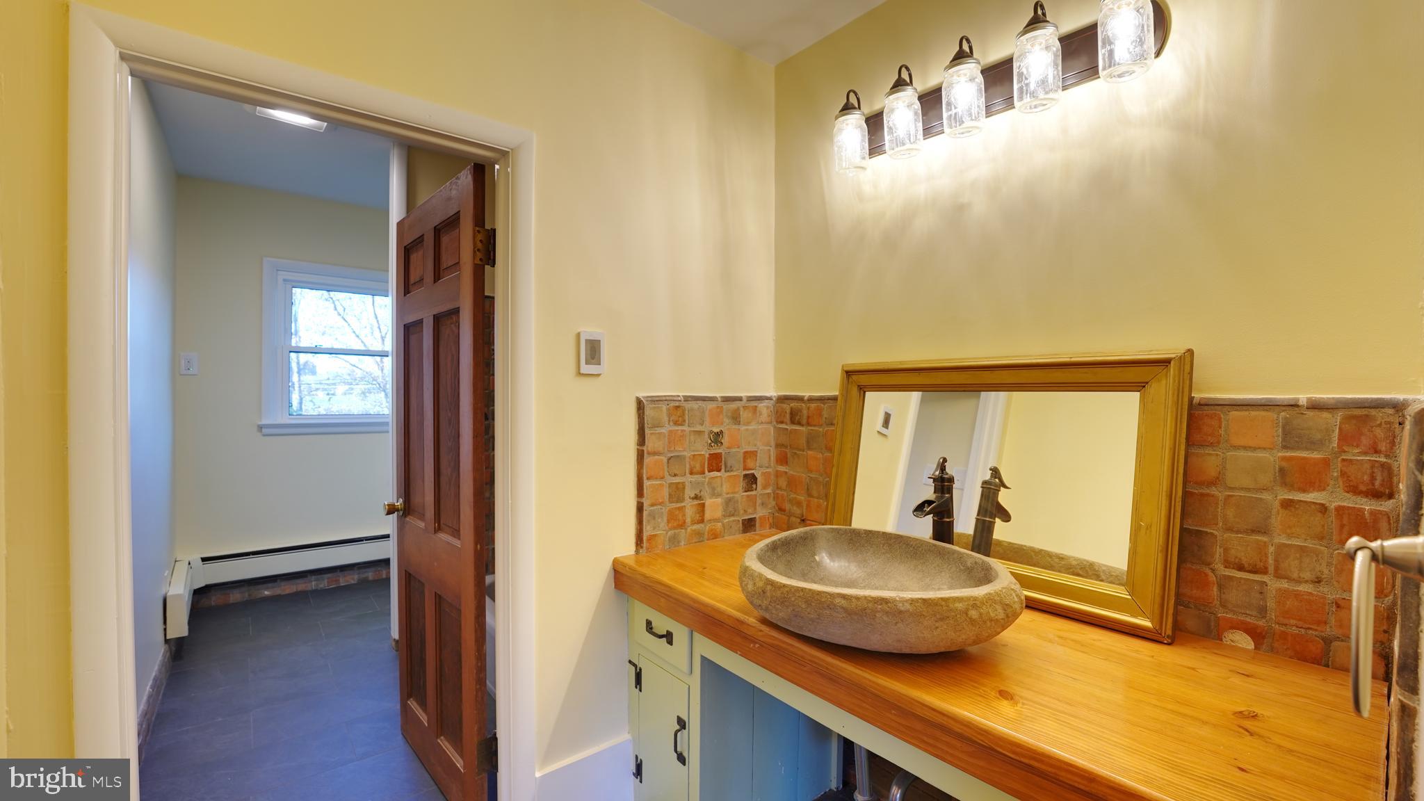 53 Iron Bridge Road Pipersville, PA 18947 - Photo 18 of 28 a bathroom with a granite countertop sink and a mirror