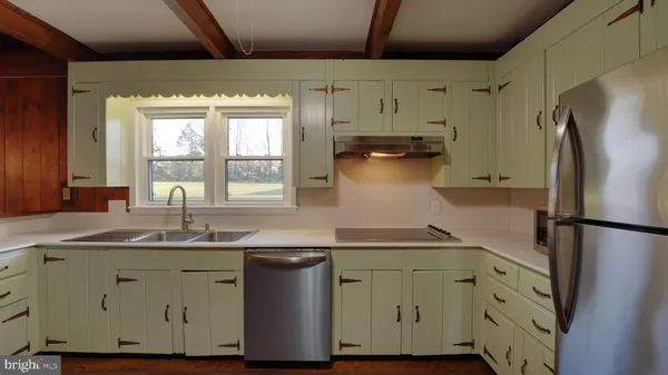 a kitchen with a sink and a refrigerator