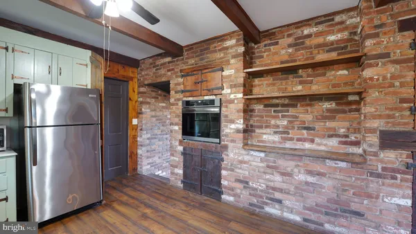 a kitchen with granite countertop a refrigerator and a stove