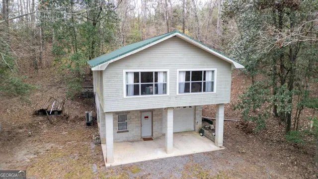 a view of a house with a yard and sitting area