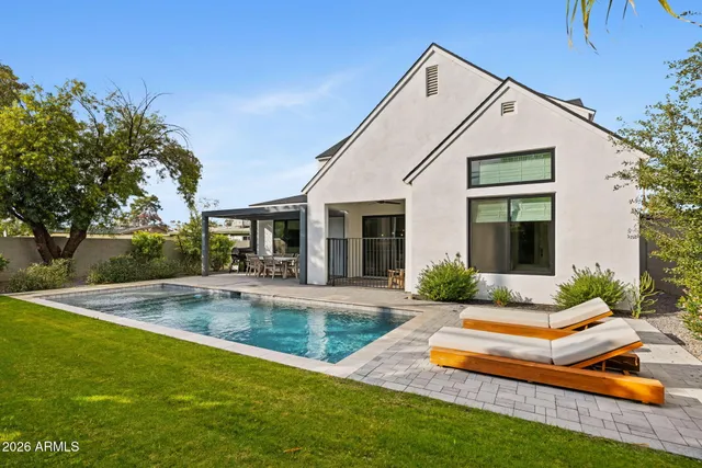 a view of a house with swimming pool and a yard