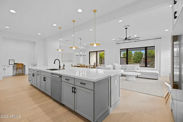 a large white kitchen with a large window