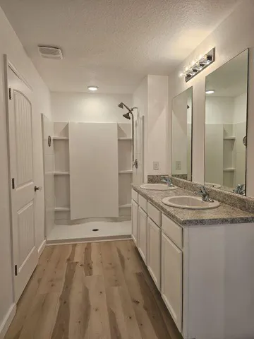 an empty room with a window and a ceiling fan