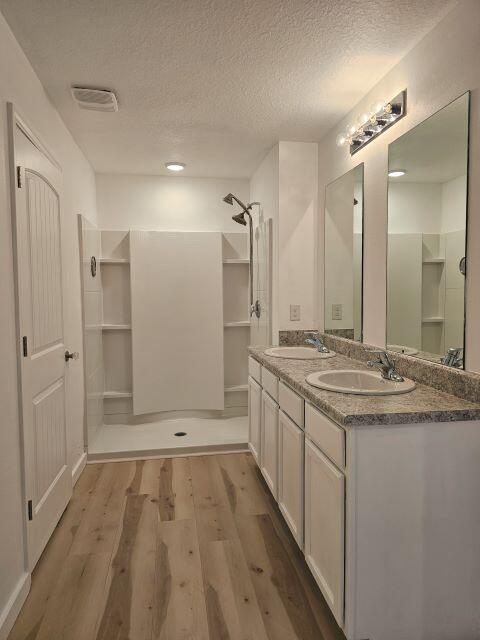 931 Merganser Way Crestview, FL 32539 - Photo 17 of 37 a bathroom with a granite countertop sink a toilet a mirror and shower