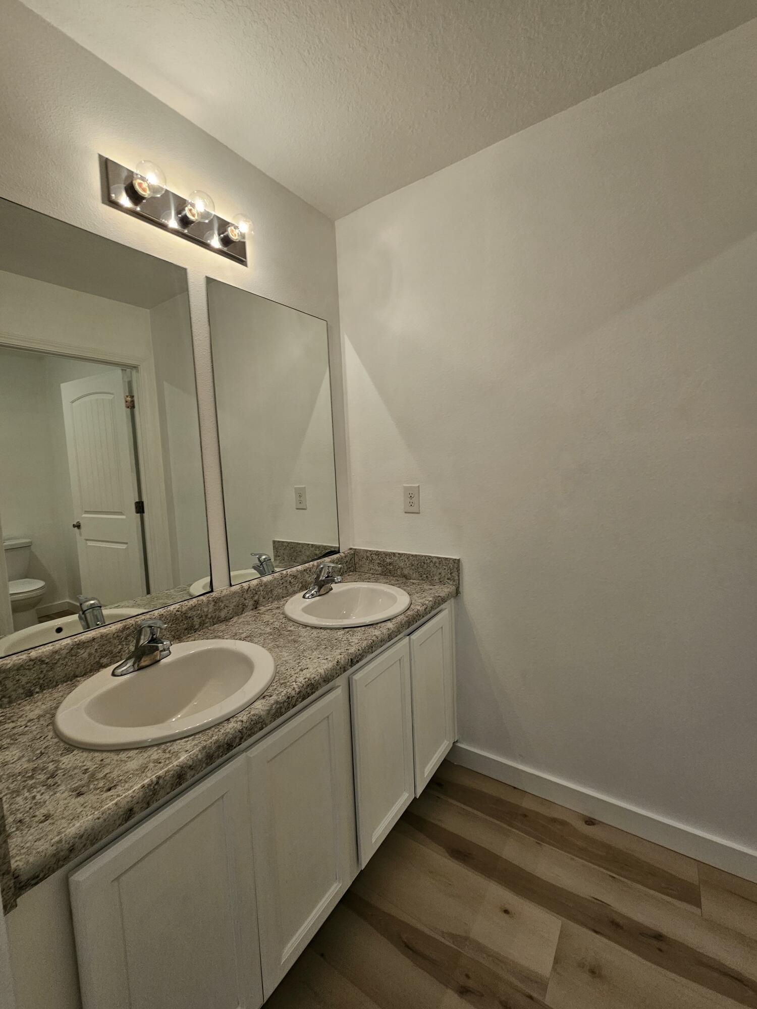 931 Merganser Way Crestview, FL 32539 - Photo 25 of 37 a bathroom with a double vanity sink and a mirror