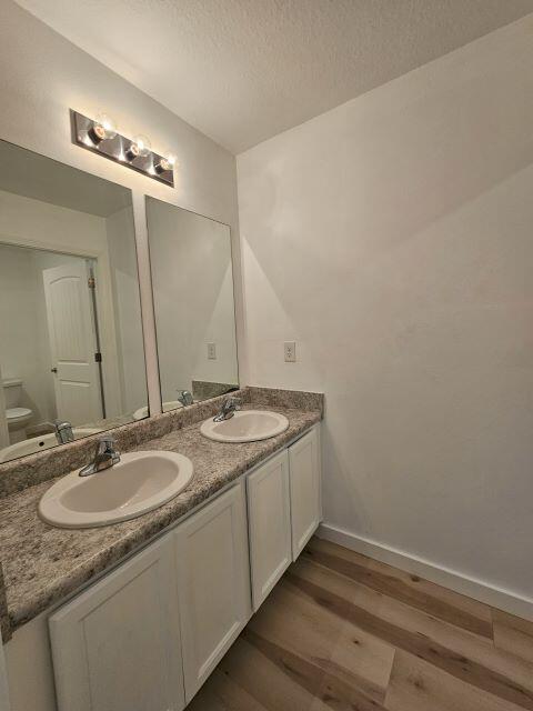 931 Merganser Way Crestview, FL 32539 - Photo 26 of 37 a bathroom with a granite countertop sink a large mirror and a vanity