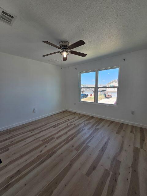 931 Merganser Way Crestview, FL 32539 - Photo 28 of 37 a view of empty room with wooden floor and fan