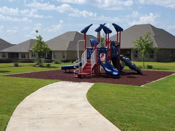 a view of outdoor space with playground and green space