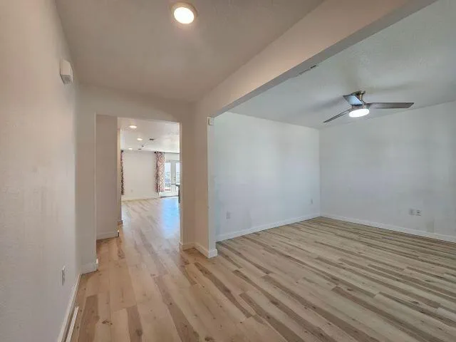 a view of empty room with wooden floor