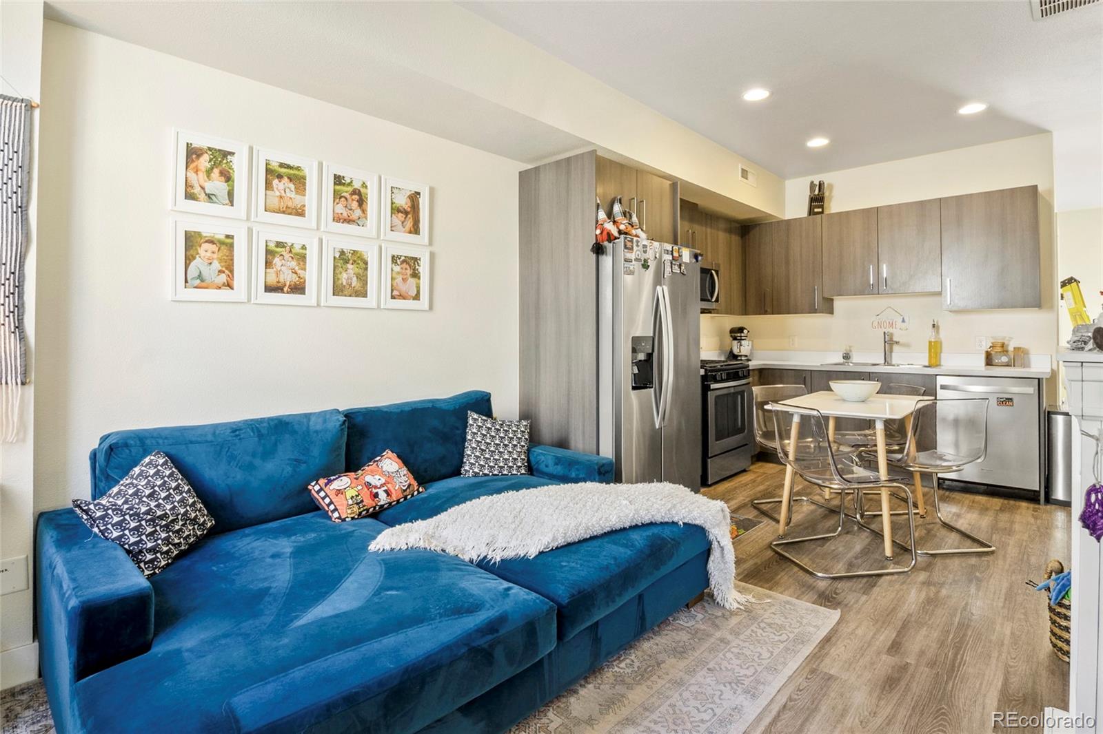 a living room with furniture kitchen and a table