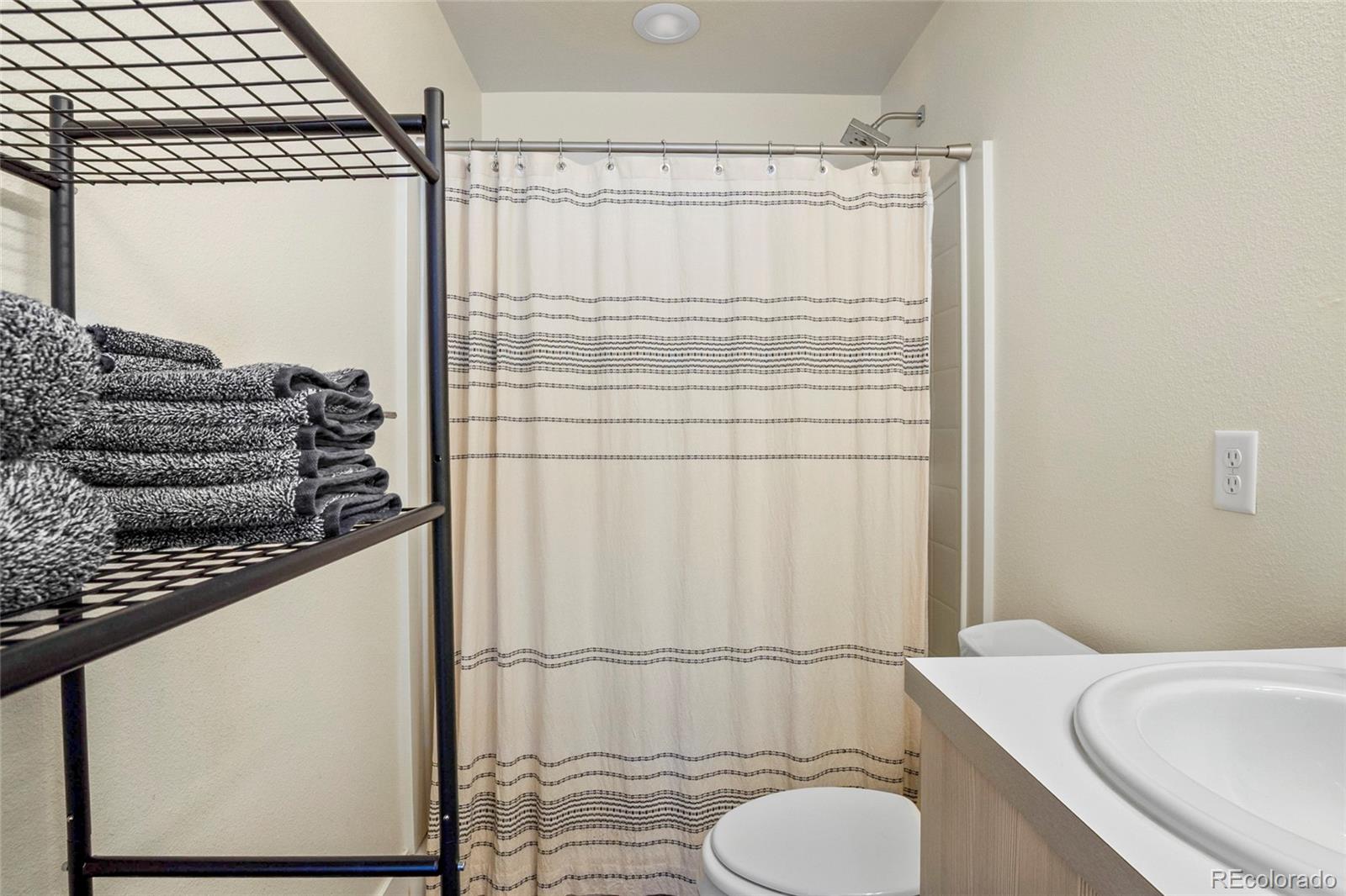 3080 Wilson Court, Unit 3 Denver, CO 80205 - Photo 25 of 28 a bathroom with a sink toilet and shower
