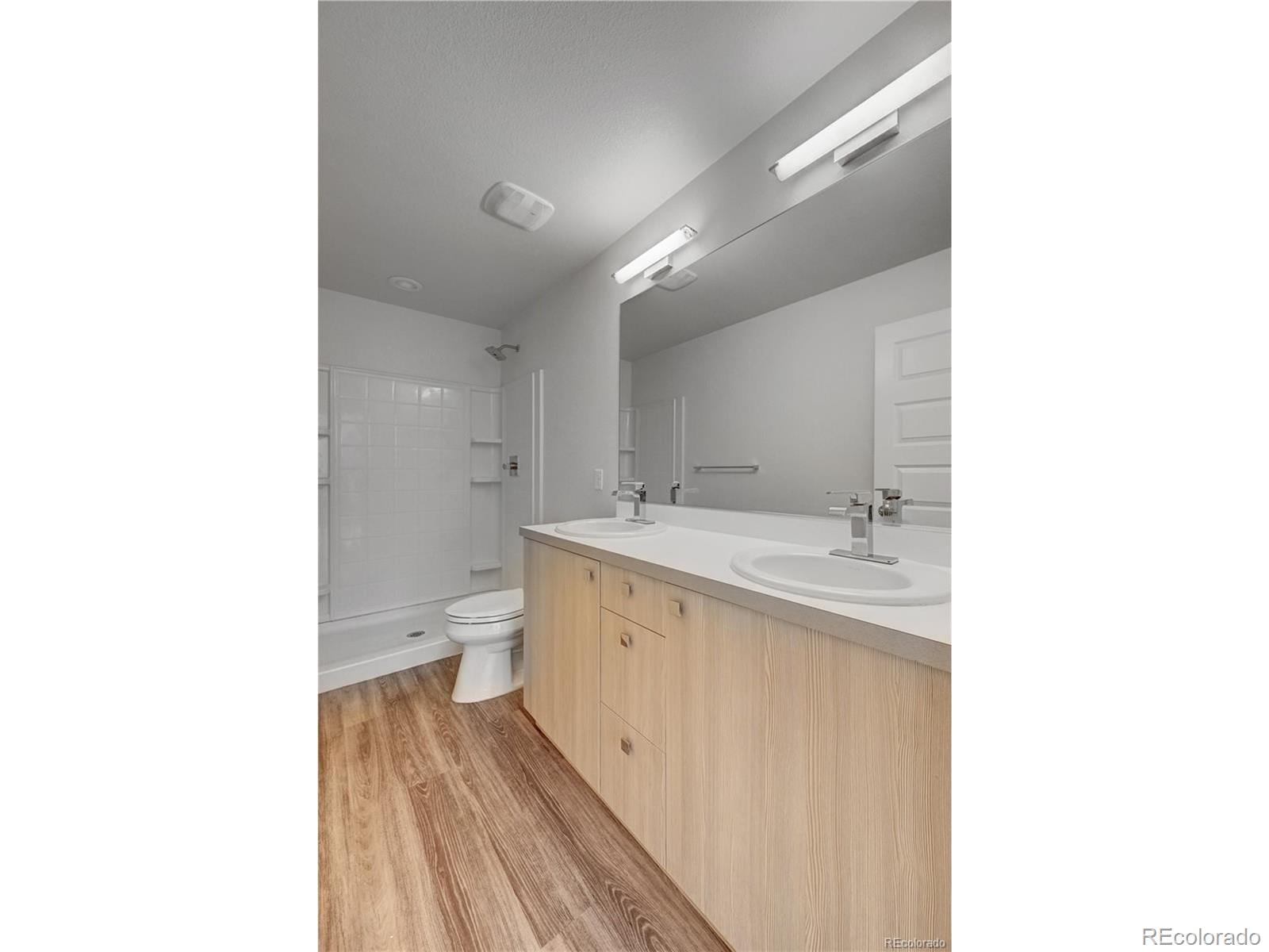 3080 Wilson Court, Unit 3 Denver, CO 80205 - Photo 26 of 28 a spacious bathroom with a double vanity sink toilet and a tub