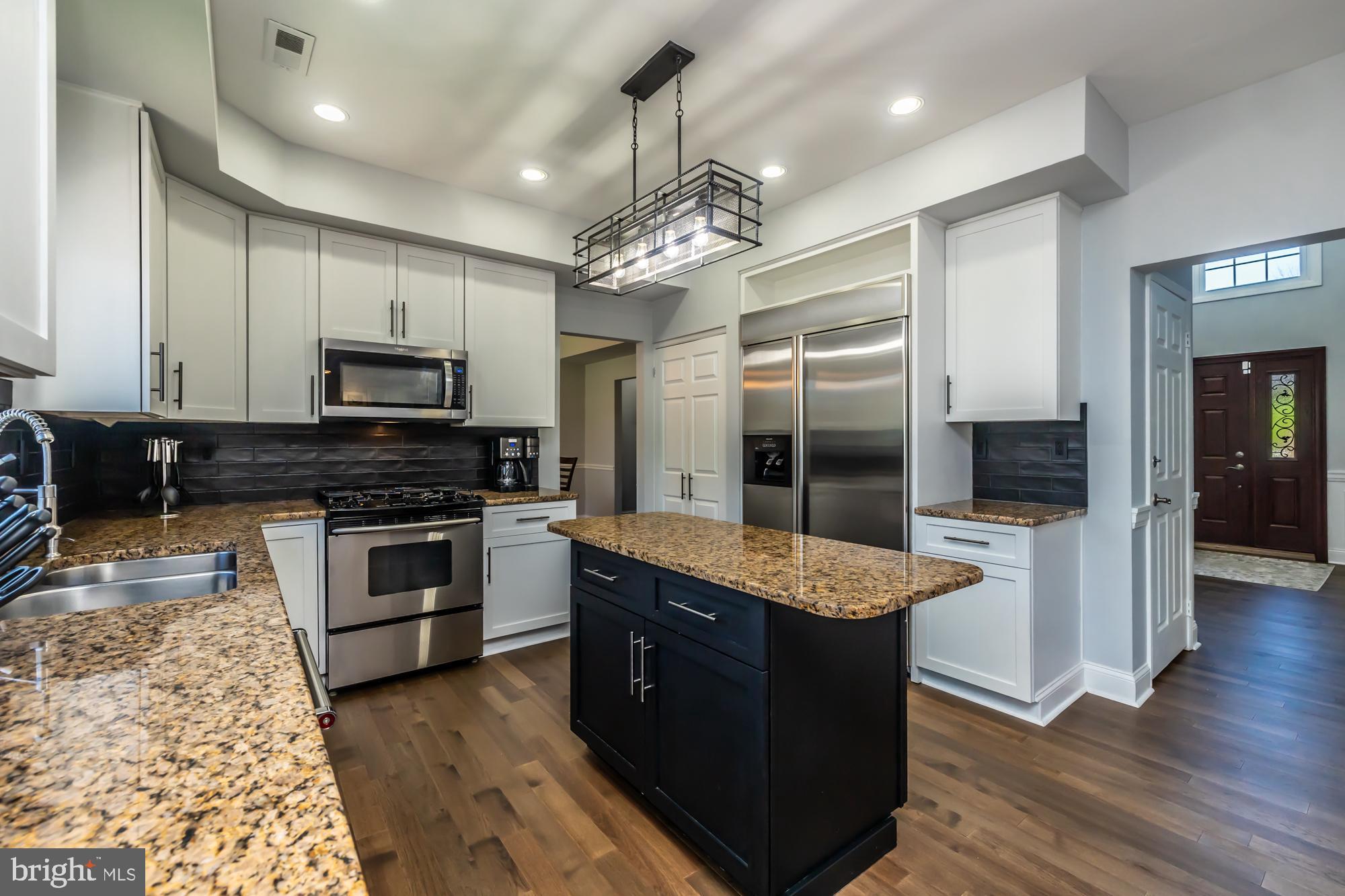 1537 Foxbury Road Ambler, PA 19002 - Photo 16 of 52 a large kitchen with granite countertop a stove refrigerator and microwave