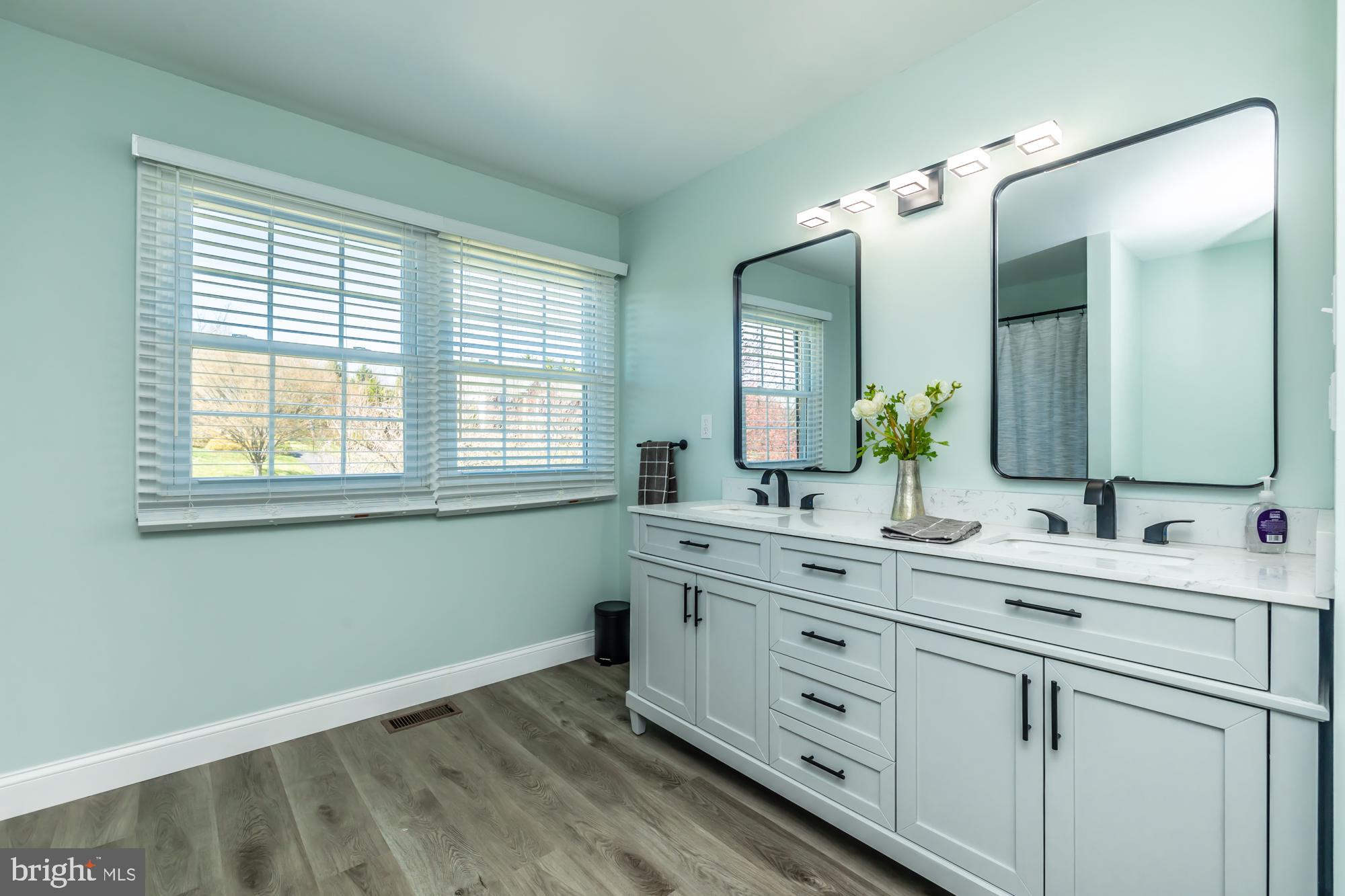 1537 Foxbury Road Ambler, PA 19002 - Photo 37 of 52 a bathroom with a double vanity sink and mirror with window
