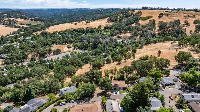 an aerial view of a house with a yard