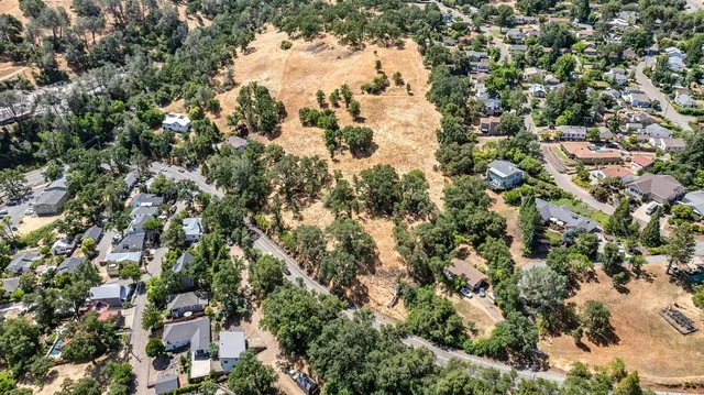an aerial view of a houses with a yard
