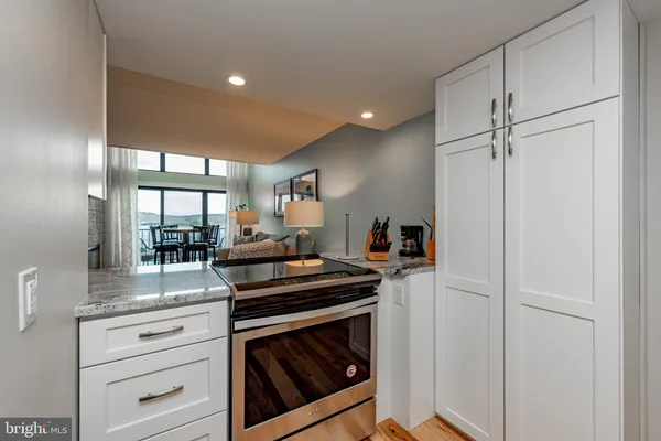 a kitchen with a refrigerator and a stove top oven