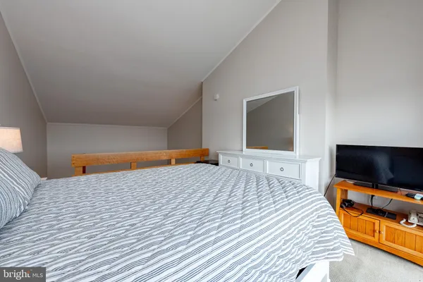 a bathroom with a granite countertop toilet sink and mirror
