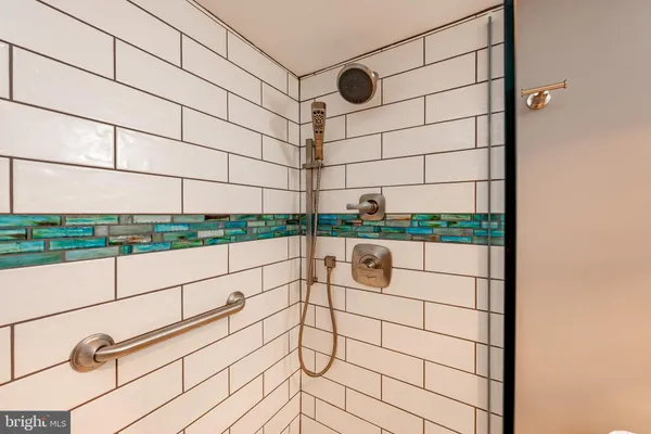 a spacious bedroom with a bed and a chair